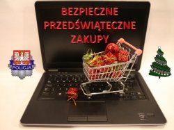 koszyk z zakupami i logo Komendy Wojewódzkiej Policji w Krakowie leżą na klawiaturze laptopa