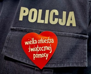 serce z napisem wielka orkiestra świątecznej pomocy pod napisem policja na granatowym tle