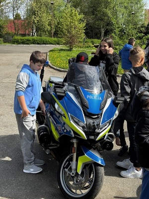 Dzieci stojące obok motocykla słuzbowego