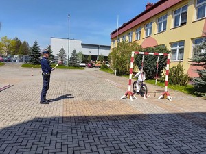 Dziewczynka jadąca na rowerze obok policjant